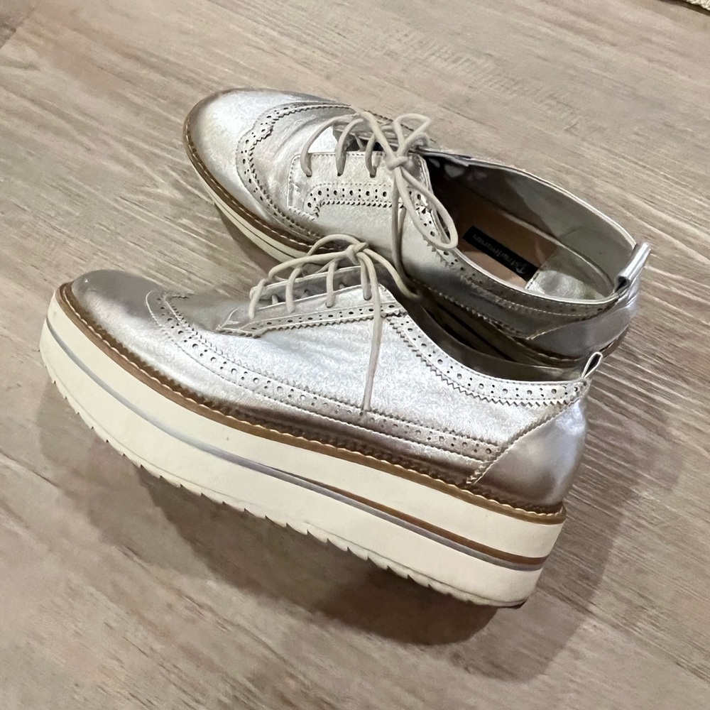 Silver oxford platform shoes.